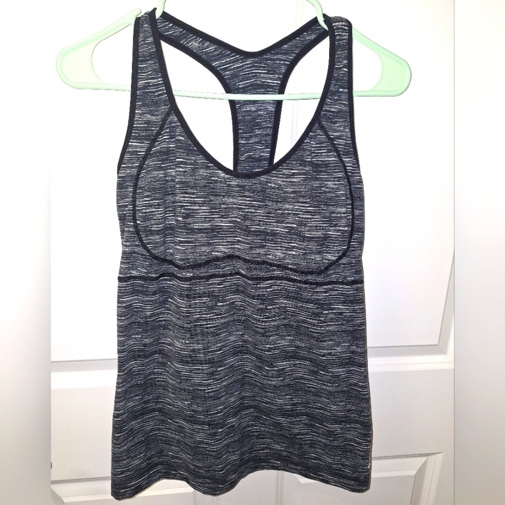 A Reebok ladies tank top in a size large with an open back. EUC. Black and grey.